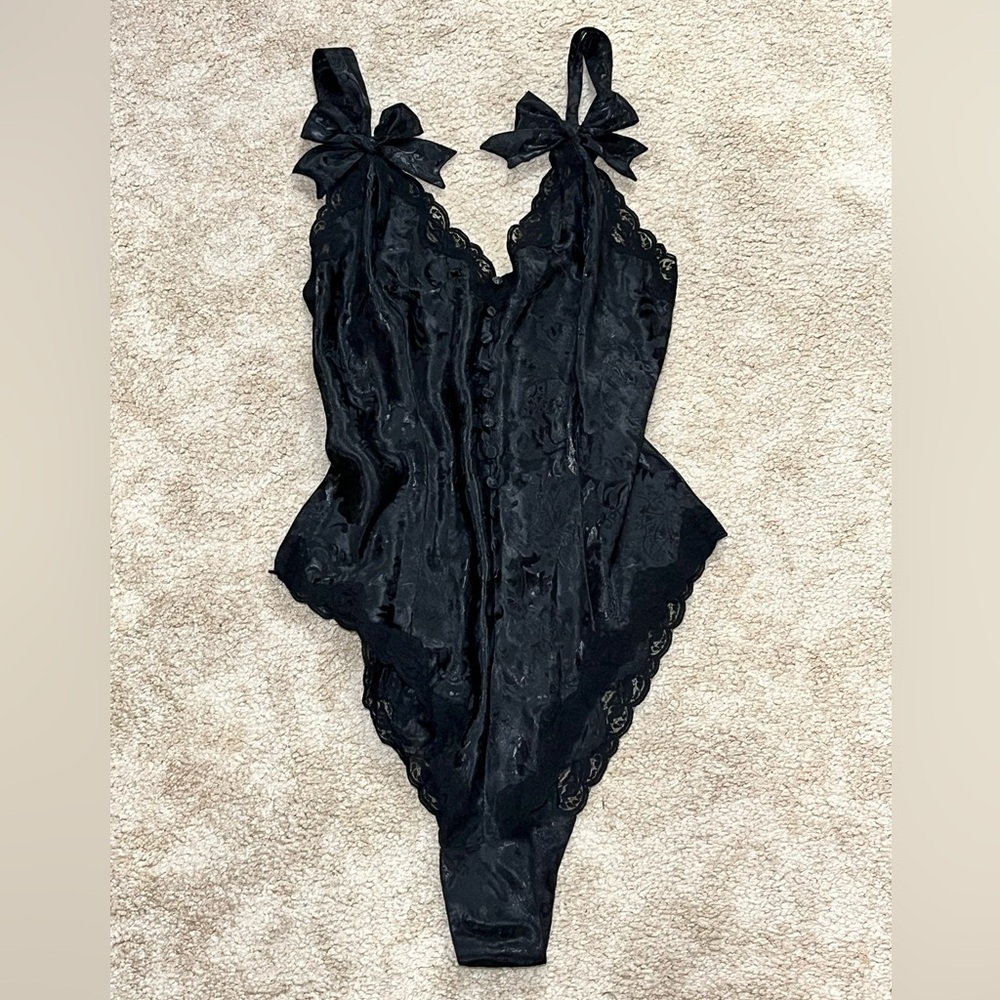 Victoria Secret lingerie, black body suit with lace and bows size medium.